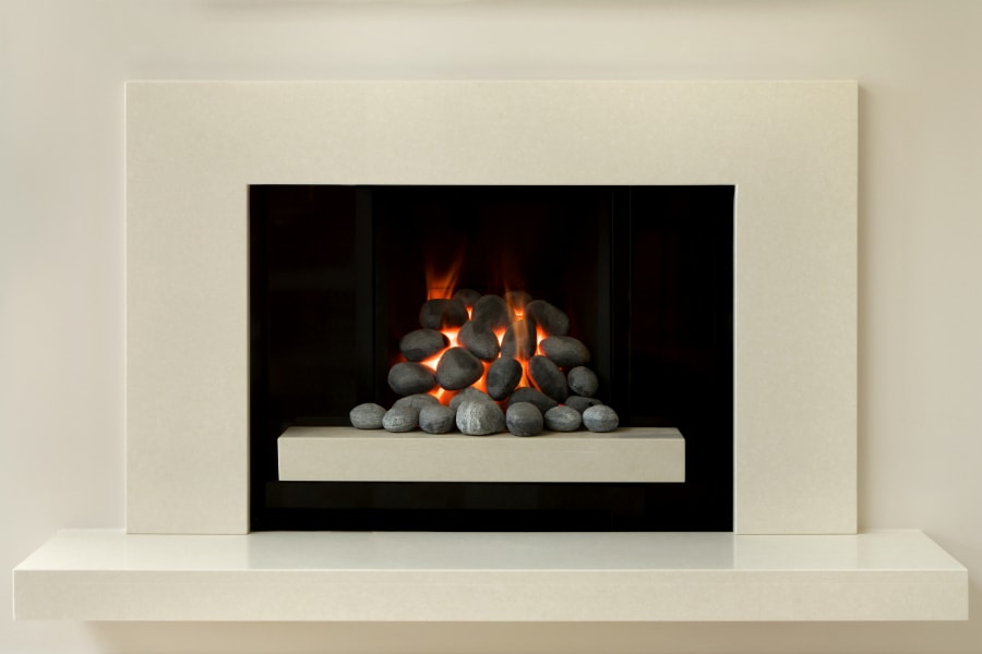 Modern coal affect gas fire in set into wall with cream surround